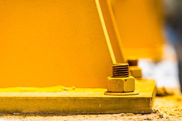 Steel anchors with base, nuts and bolts painted yellow