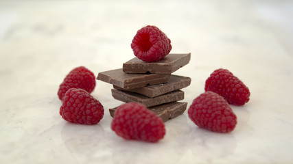 Raspberries and Chocolate Stack on a Marble Background Horizontal