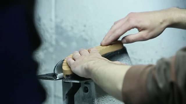 Slow motion of the painting soles of shoes. Handmade labor.