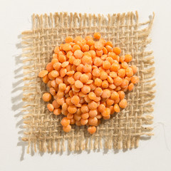 Turkish Red Lentil legume.  Close up of grains over burlap.
