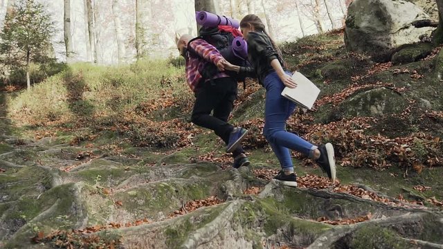 Tourist man and woman climb a high path to the mountains. Concept of carefree modern life