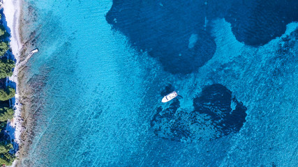 Aerial view of cozy mediterranean island. Blue lagoon, island paradise. Adriatic Sea of Croatia, popular touristic destination. Clear sea water.
