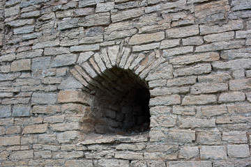 Arrowslit in the ancient stone wall
