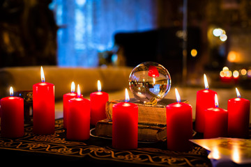 Crystal ball to prophesy or esoteric clairvoyance during a Seance in the candle light