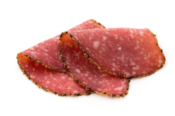 Salami slices isolated on the white background.