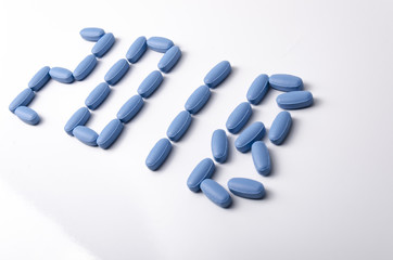 Creative 2018 new year concept made out blue medical tablets over a white background.