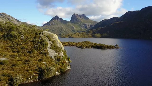 Drone Flying over Lake with mountains in the back