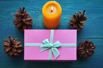 Christmas Composition with Gifts and candle on wooden table.