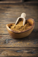 Brown sugar on wooden background