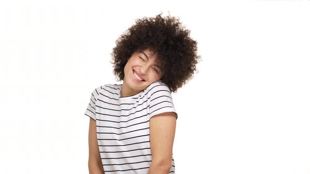 portrait of caucasian woman with cunning sly look shrugging throwing hands up smiling making helpless gesture having Oops expression on her face over white background. Concept of emotions