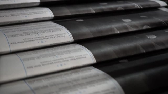 Print the newspaper from a short distance. The process of offset and roll printing. Production of the newspaper. Paper passing from the press.