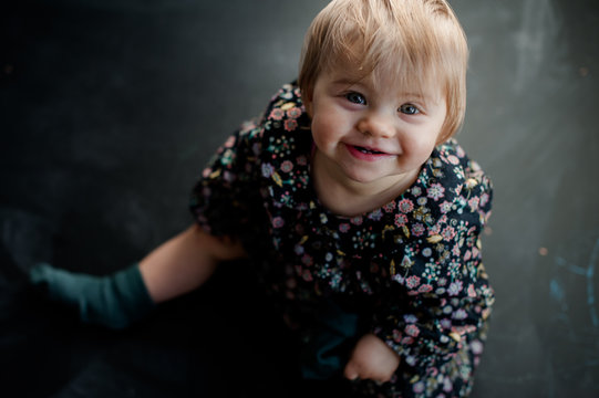 blonde baby girl laughing and looking up