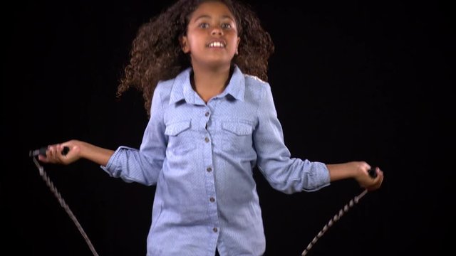 Cute girl jumping rope in slow motion.