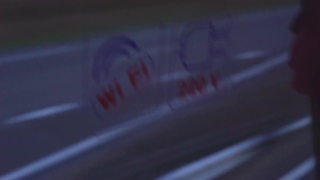 double-decker tourist bus. the bus has a 220 volt socket and wireless internet. sticker with a pointer "free wi-fi" on the glass. car driving forward. Shooting on a sunset background. 4k