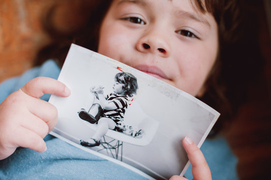 girl showing her old photo