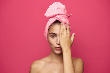 young woman with a towel on her head covers half a person's hand