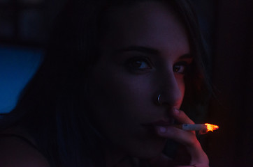 Young girl smoking in the night