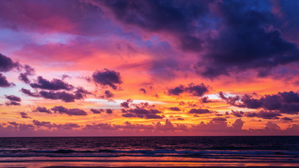 Colorful cloudy sunset sky of twilight at beach of Phuket, Thailand. Dark clouds floating before rain storm coming at night.