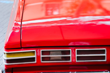 Close-up of back headlight of red vintage car