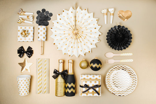 Flat lay stylish set: champagne, gift, female shoes, christmas balls and golden holiday decoration. Flat lay, top view.