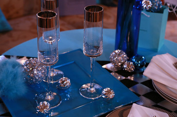 A glass and the decoration on the table of the blue