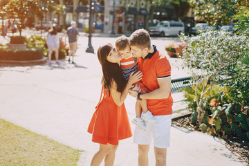 beautiful family in red walking down the street and the Park