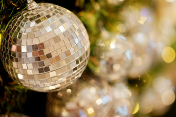 close up mirror ball or Christmas ball to decorative for Christmas festival with bokeh colorful tone background. Have some space for write wording
