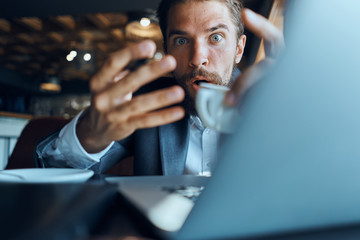 businessman is surprised in a cafe