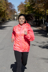 Fototapeta premium runner sport woman in Autumn sportswear running and training on jogging outdoors workout in city park smiling happy