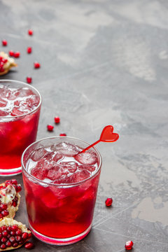Pomegranate juice with ice in glass decorated heart