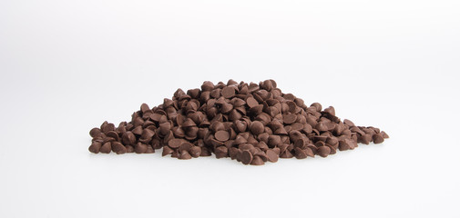Chocolate chip morsels spread on a background.
