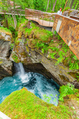 Tourist with camera on Gudbrandsjuvet waterfall, Norway