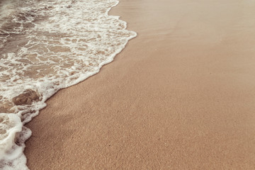 Soft sea sand and clean white wave of the sea on the sandy beach for summer nature background