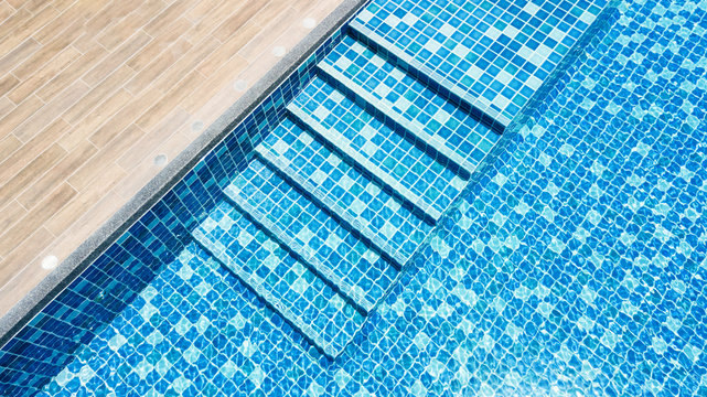 swimming pool with blue mosaic with stair step view from top