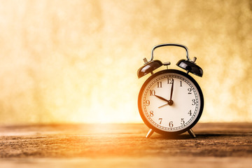 black alarm clock with blur bokeh background with free copyspace for your text