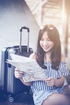 beautiful happiness young asian girl in casual dress traveling alone at train station or airport with backpack vintage tone photo concept