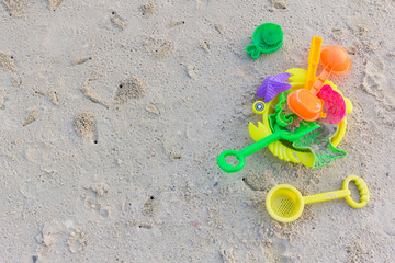 Fototapeta na wymiar Plastic toys sand on the sea beach background.