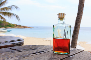 Beverrage alcohol is brandy bottle on wood table. - obrazy, fototapety, plakaty