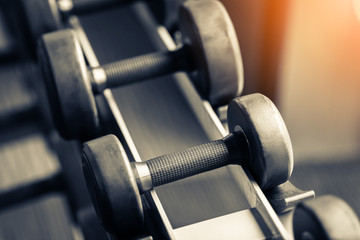 Rows of dumbbells in the gym with hign contrast and  color tone sport and health concept