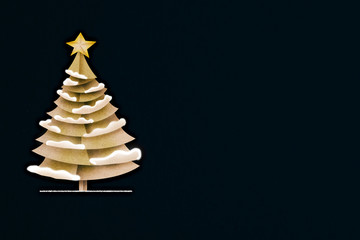 xmas greeting card with pine tree paper cut on dark blue color background