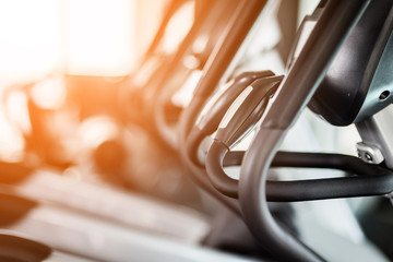 close up treadmill in fitness room background with color tone and light flare effect