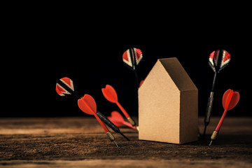 house model cardboard with dart arrow on wooden table business strategy ideas concept with free copyspace for your texts