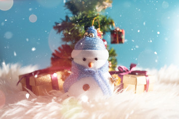 Happy snowman standing in blue winter christmas snow background. Merry christmas and happy new year greeting card with copy-space. Christmas celebration holiday background