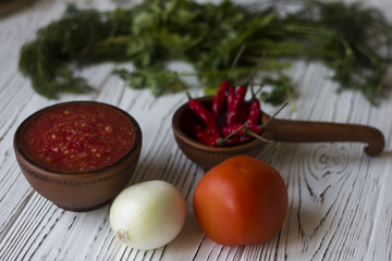 Fototapeta na wymiar vegetarian dishes and vegetables - tomato, chilli and fresh herbs - dill parsley Basil