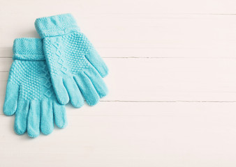 blue gloves on white wooden background