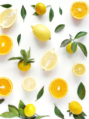 Food pattern of fresh fruit in a cut. Oranges, lemons slices , tangerines with green leaves. Composition from fruits, top view, flat lay. Citrus fruits background, wallpaper.	