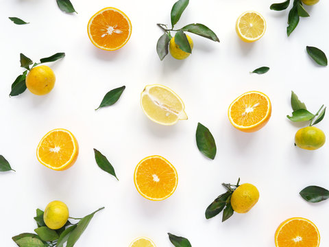 Food pattern of fresh fruit in a cut. Oranges, lemons slices , tangerines with green leaves. Composition from fruits, top view, flat lay. Citrus fruits background, wallpaper.	