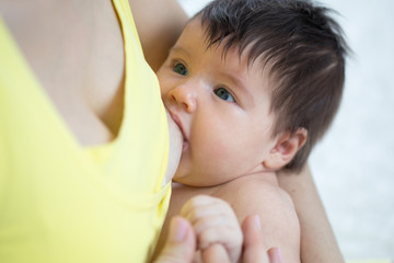 Baby feeds on mother's breasts milk