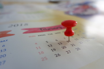 Calendar with red pin for planning