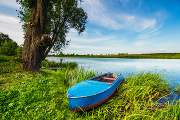 Boat on the shore in a beautiful summer landscape